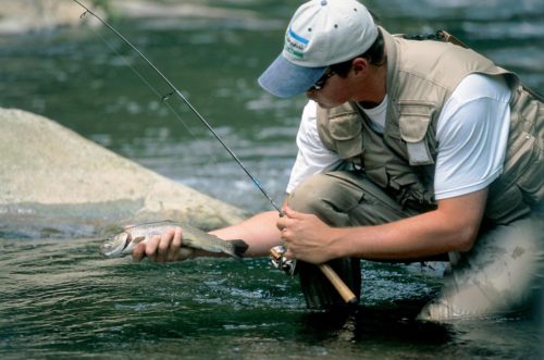 Angler holding a cutthroat trout