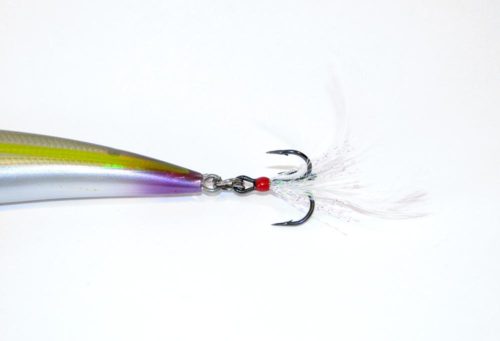A treble hook with a feather attached to it