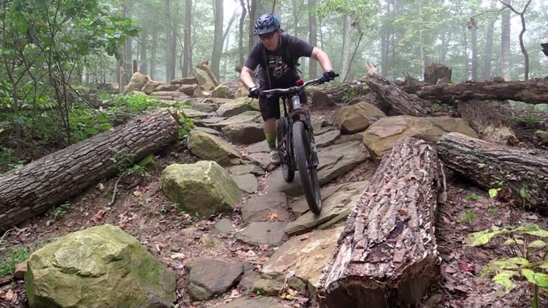Someone riding a mountain bike over rocks.